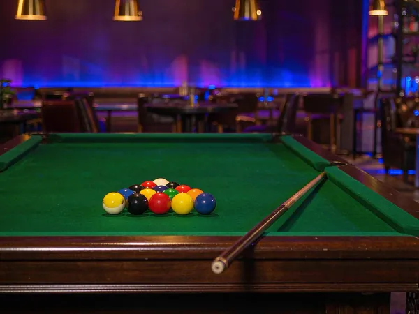 playrupees Billiard balls on a green pool table
